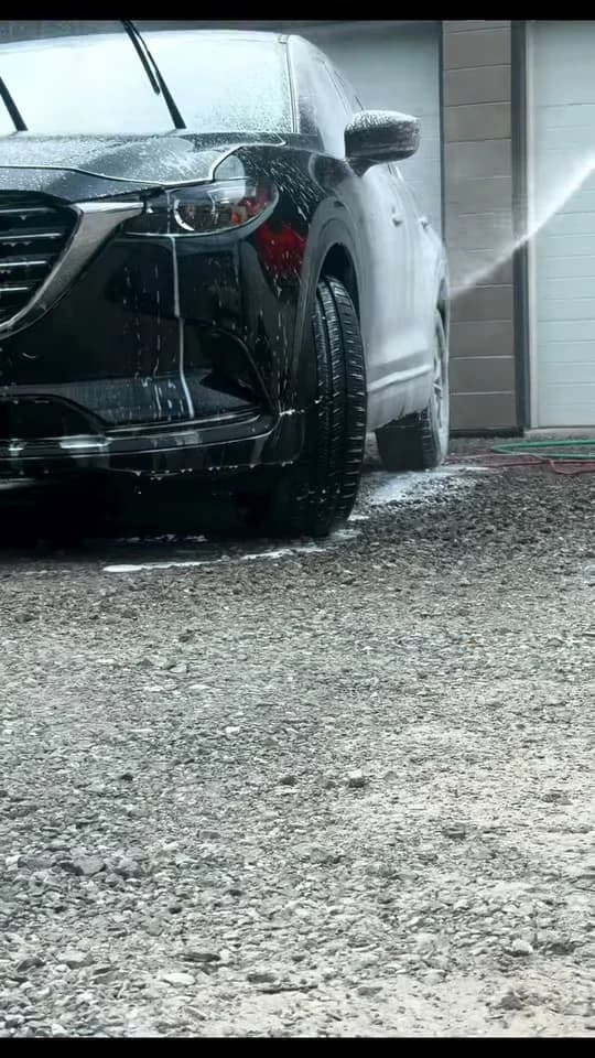 Black Mazda SUV during exterior washing