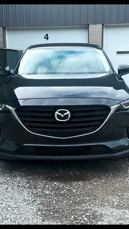 Finished black Mazda SUV in daylight
